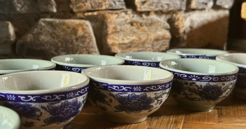 Several small ceramic tea cups with blue floral patterns