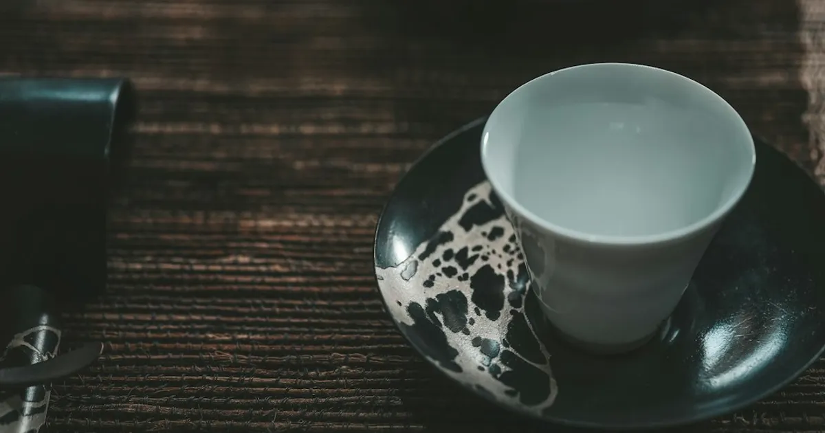 white and blue floral ceramic teacup on saucer